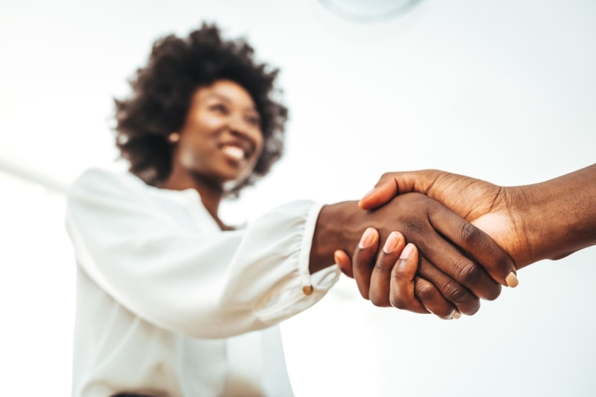 Two people shaking hands in a business setting